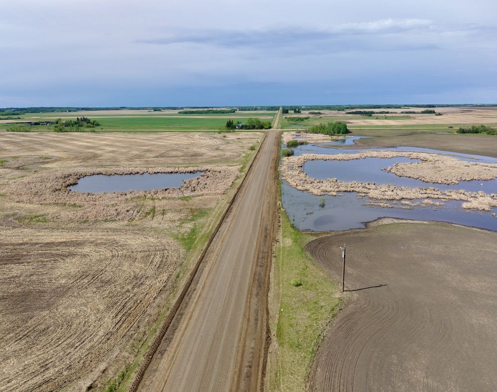 Aerial view of rural road maintenance in Camrose County