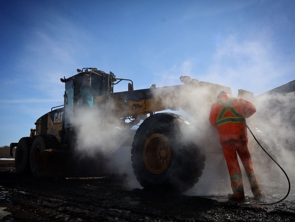 RTRC worker in full PPE performing equipment maintenance