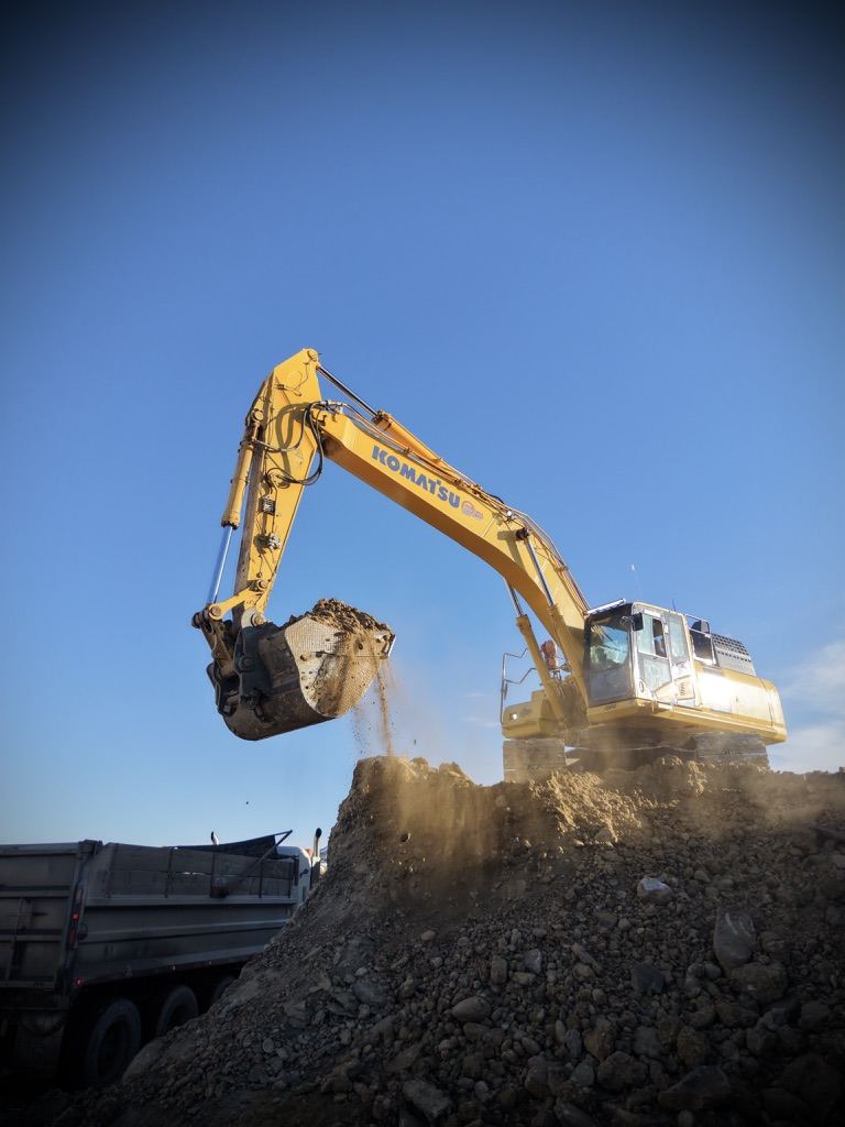 Excavator loading gravel in an Alberta pit