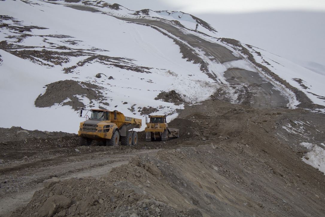 Rock truck placing material on the roadway