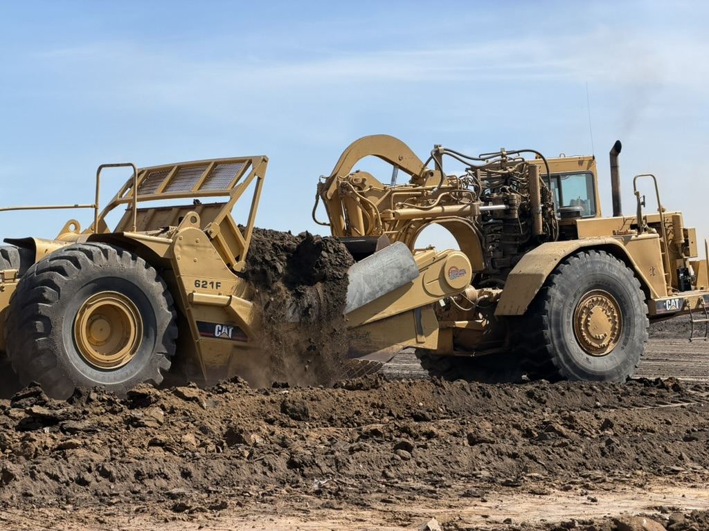 Scraper stripping overburden during pit development